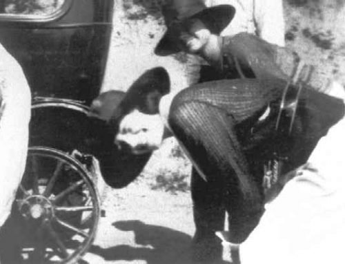 1930-1939 Two women assisting in the changing of a tire