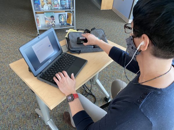 librarian using a Chromebook and mobile hot spot