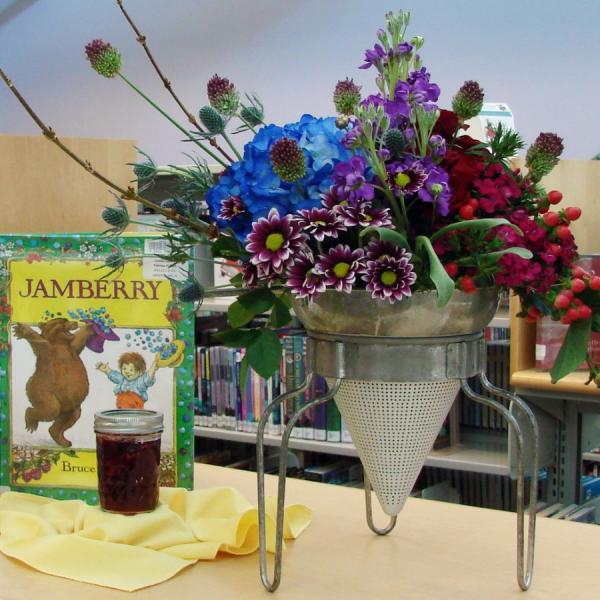 2023BooksinBloom Floral arrangement next to Jamberry book