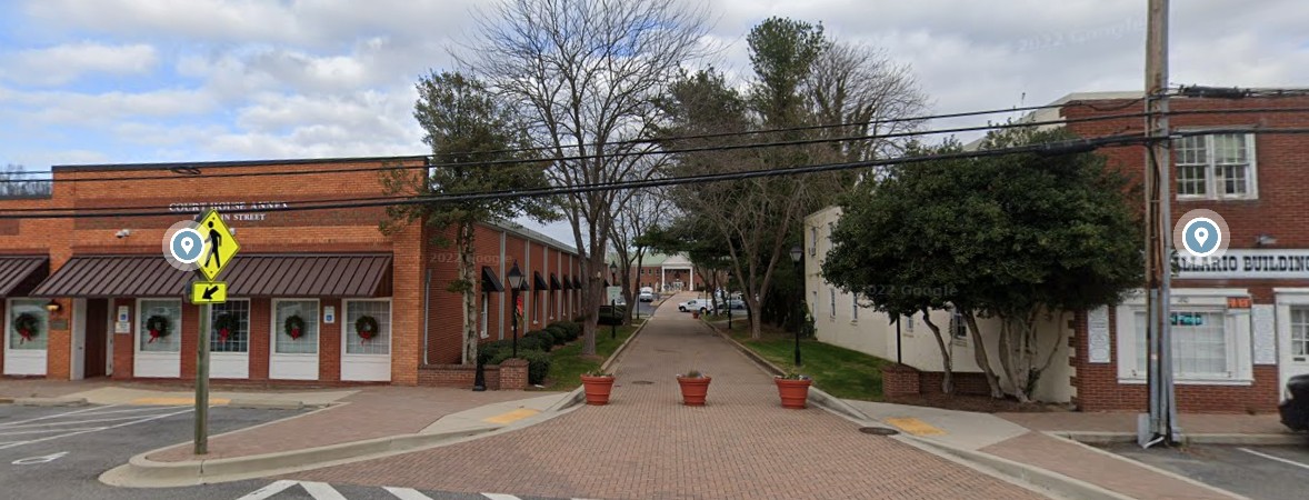 Picture of red brick path between the Courthouse Annex and the Vallaro Building